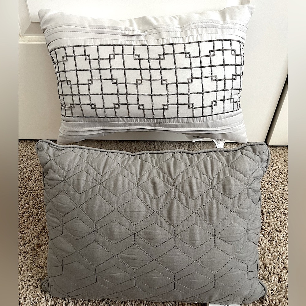 2 grey throw pillows